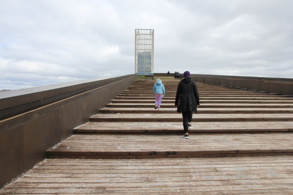 Outdoor staircase rising toward a tower structure.